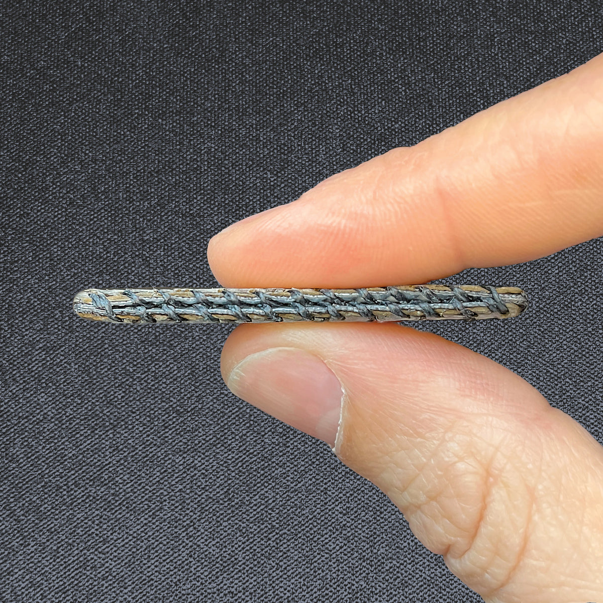 Wildcard, held between two fingers to show its slim profile