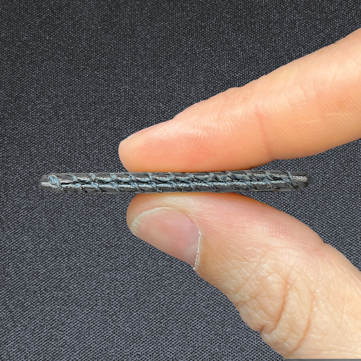 Wildcard, held between two fingers to show its slim profile